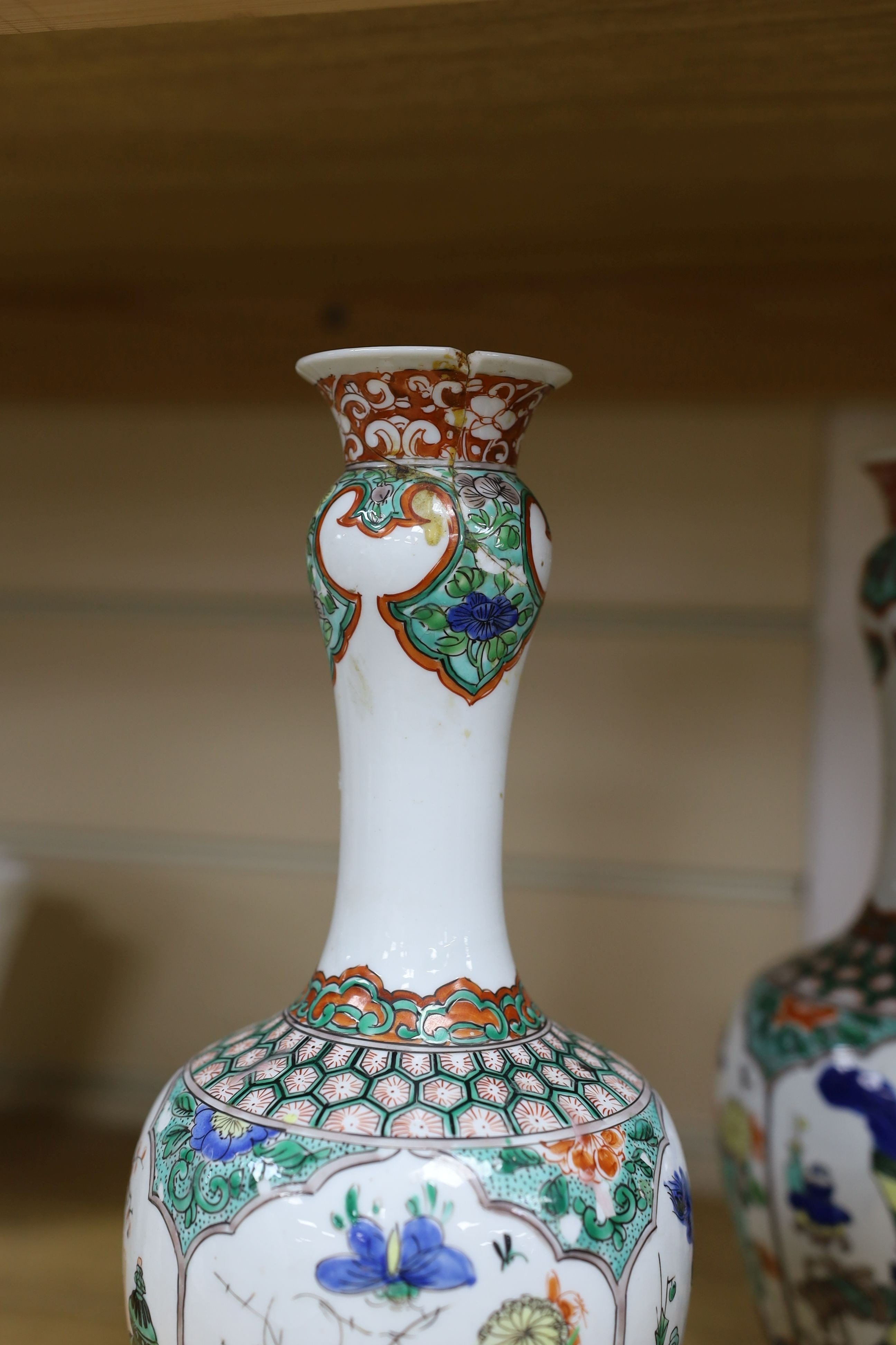 A pair Samson of Paris vases in the Chinese famille verte style and a Chinese Qianlong famille rose garlic neck vase with blue panelling motif, tallest 26cm